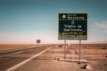 The Tropic of Capricorn sign stands prominently along Ruta del Desierto in the Atacama Desert, near San Pedro de Atacama, Chile, marking a significant geographical location.