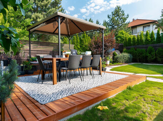 Obraz premium Minimalistic English modern garden with table and chairs. Sunny summers day with green plants and decking on the patio
