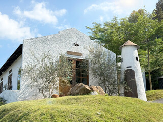 Vintage ancient rural countryside house or lodge, with rough textured white stucco wall, and...