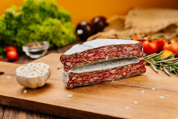 Dry-cured salami on board, ideal for rustic charcuterie presentations and gourmet food styling