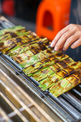  Grilling otak otak is being grilled while being turned over
