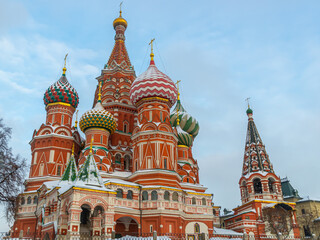 Fototapeta premium St. Basil's Cathedral in winter on Red Square in Moscow. The entrance to the ancient temple with vaults is decorated with samples. A monument of Russian architecture. An object of cultural heritage.