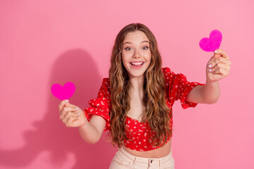 Photo portrait of lovely teen lady excited hold heart postcards dressed stylish red garment isolated on pink color background