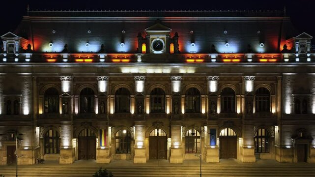 Aerial drone view of the illuminated Palace of Justice in Bucharest, Romania, at night