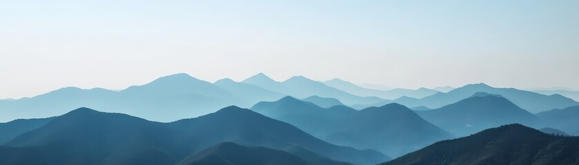 Fototapeta premium Majestic mountain range with layers of peaks creating a serene, misty landscape. Perfect for nature, travel, and adventure photography.