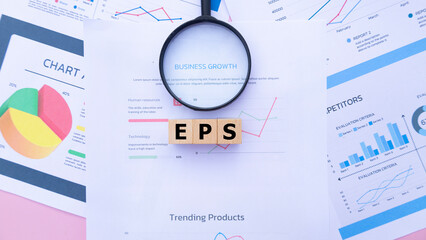 Three wooden cubes with the word EPS on graph sheets, abbreviation for Earnings Per Share. Business...
