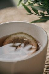 Cup of tea with lemon on wooden table. Selective focus.