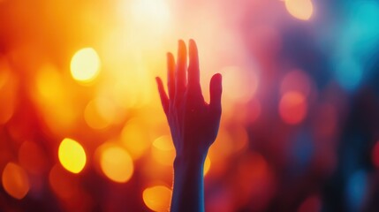 Silhouette of a person raising his hands on a sunset background