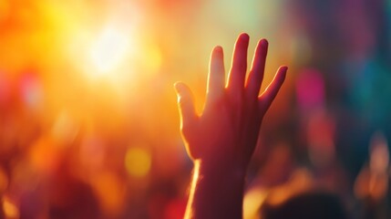 Silhouette of a person raising his hands on a sunset background