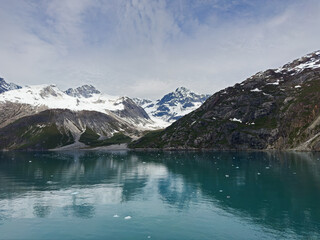 Snowy mountains and turquoise water with floating ice are typical features in Alaska's Glacier Bay National Park.