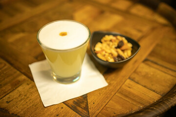 Pisco sour on wooden table