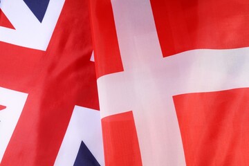 Flags of the UK and Denmark waving together in a display of unity