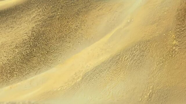 Static video of a beautiful abstract wave background with sandy, grainy texture effect, yellow and brown color rendered in 3d.