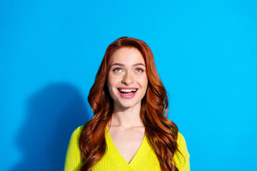 Photo of impressed girl with ginger hairstyle dressed yellow knit cardigan look at promo empty...