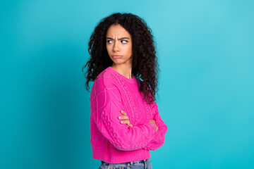 Photo portrait of lovely teen lady crossed hands look moody empty space dressed stylish pink garment isolated on cyan color background