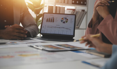 Close up of Business team analyzing income charts and graphs with modern laptop computer. Business analysis and strategy concept.