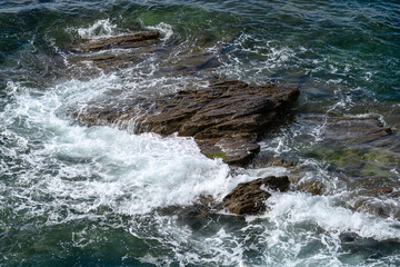 waves splashing and water spray over the rocks in the sea