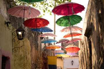 Cartagena de Indias umbrellas in historical Downton graffiti street, Colombia