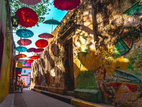 Cartagena de Indias umbrellas in historical Downton graffiti street, Colombia