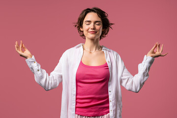 Tranquil woman relaxing, meditating, refuses stress. Charming lady breathes deeply, calms down,...