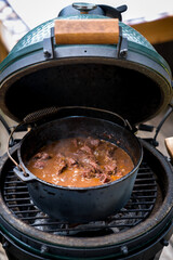 ready to eat - goulash from venison meat, from a roebuck -  cooked in a dutch oven on a charcoal grill at outdoor © DoreenB. Photography