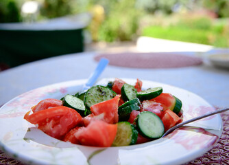 A salad dish with tomatoes and cucumber 
