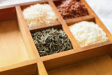 wooden box with four sections filled with rice white and black close-up