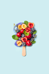 Assorted fresh fruit arranged on a popsicle stick