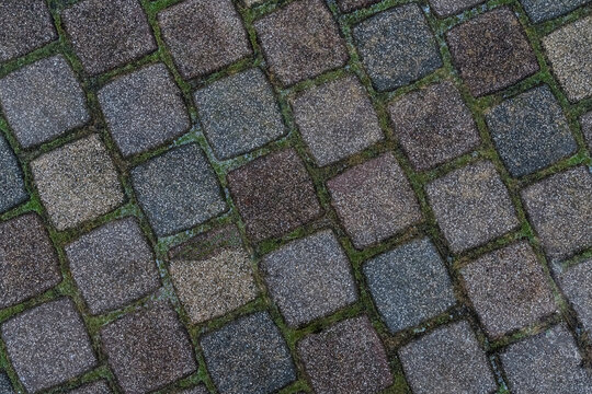 Stone texture. Square tiles in brown and gray shades in even layers at an angle