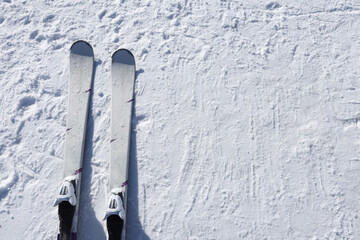 Mountain skis on bright alpine snow. Winter holidays. Extreme sport.  Vacation, travel content. Copy space