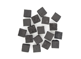 Pile of charcoal cubes for hookah isolated on white background