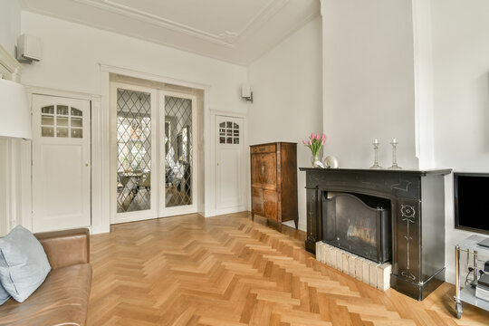 Elegant living room with traditional fireplace and herringbone floor