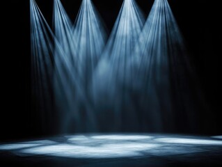 A dramatic stage scene featuring multiple beams of light shining down on a dark backdrop, perfect for performances and events.