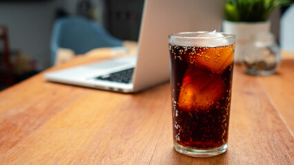Double cool ice soft drink cola carbonated liquid fresh food with soda water, Cola drinking with ice in glass ready to refresh you, A cola soft drink is placed on the desk.