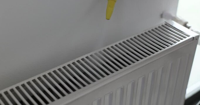 Maneuvering of advanced steam cleaner over heater at home. Device ability to sanitize challenging surfaces contributing to cleaner environment