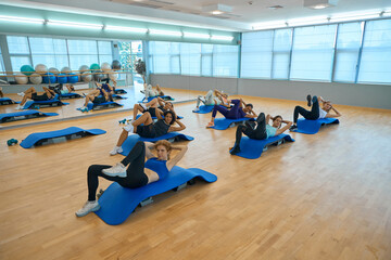 Women perform exercises to strengthen their abdominal muscles