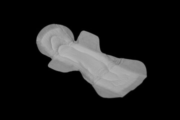 A women's disposable menstrual pad designed for regular flow, showcased against a black background.