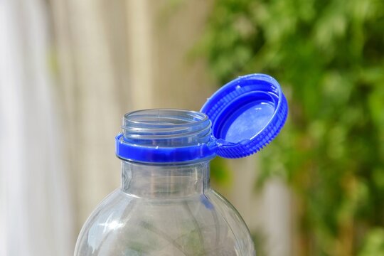 A bottle of water with the cap attached after the bottle has been opened.