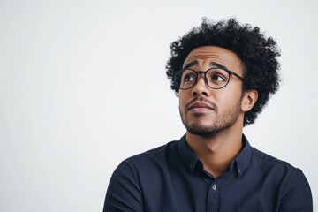 Fototapeta premium Thoughtful Young African American Man in Glasses on White Background for Business and Lifestyle Concepts