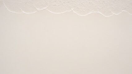 top view of waves on the edge of a white sand beach with texture as a background.