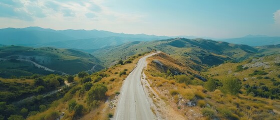 Aerial View of Serpentine Mountain Road Amidst Breathtaking Scenery