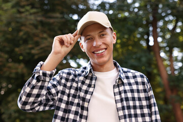 Portrait of smiling man in baseball cap outdoors