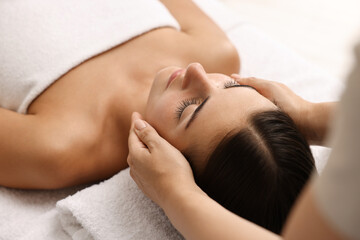 Attractive woman enjoying face massage, closeup. Beauty procedure