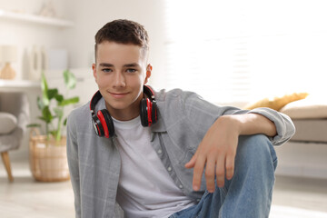 Portrait of teenage boy with headphones at home