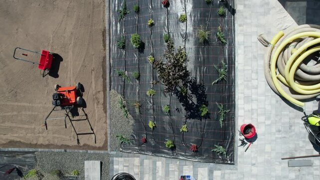 Landscaping Project in Progress at Residential Property With Paving and Planting Details. Weed barier protection and rocks.