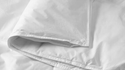 Closeup of duvets and bed sheets.