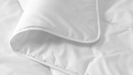 Closeup of duvets and bed sheets.