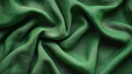 Fototapeta premium Green fabric with flowing folds and textured surface