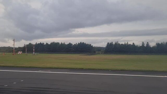 Side Window View of Domestic Flight from London Stansted Airport's Runway During Early Morning Flight to Edinburgh City of Scotland United Kingdom. August 29th, 2024
