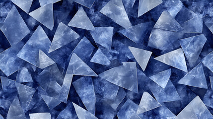 Fototapeta premium A detailed view of varying blue and clear triangular glass pieces scattered across a textured surface, creating an abstract design